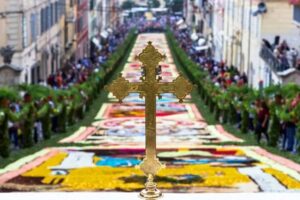 Image of a street decorated with colorful flowers and elaborate floral arrangements, used for the celebrations of a traditional Spanish festival.
